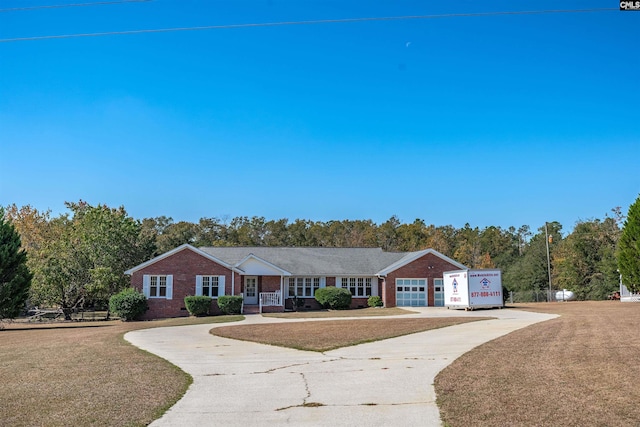 ranch-style home with a garage and a front lawn