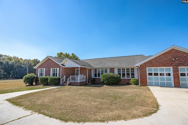 ranch-style house featuring a garage, a front yard, and a porch