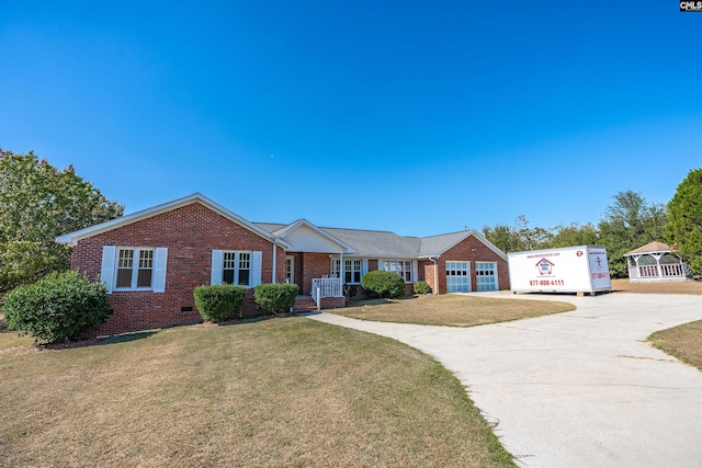 ranch-style home featuring a garage and a front yard