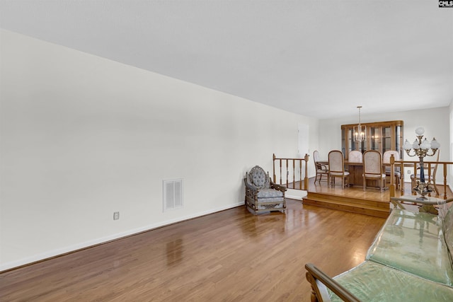 living room featuring a notable chandelier and wood-type flooring