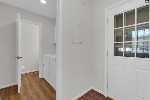 doorway featuring electric panel and light hardwood / wood-style floors