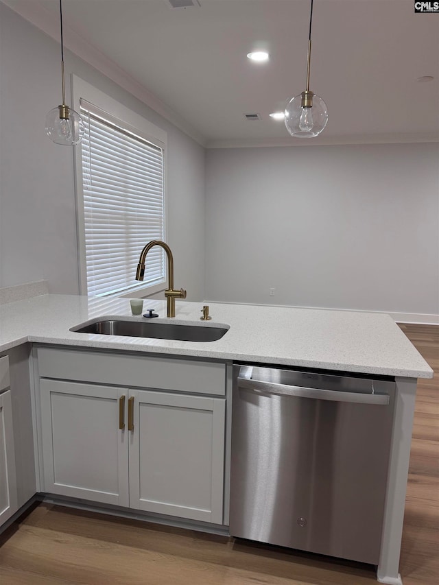 kitchen with stainless steel dishwasher, sink, kitchen peninsula, and hanging light fixtures