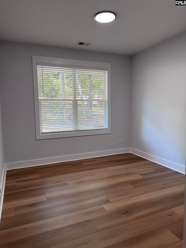 spare room with dark hardwood / wood-style floors