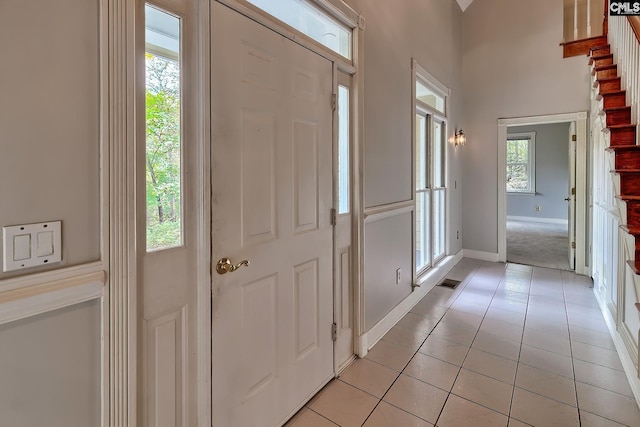 115 Cedar Lake Rd, Blythewood, SC 29016 - foyer featuring baseboards, light tile patterned floors, light carpet, and a towering ceiling
