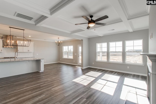 unfurnished living room featuring dark wood-style floors, crown molding, visible vents, coffered ceiling, and baseboards