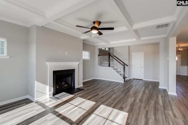 unfurnished living room featuring dark wood-style flooring, stairway, a fireplace with flush hearth, and visible vents