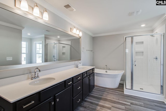 bathroom with crown molding, visible vents, a sink, and a shower stall