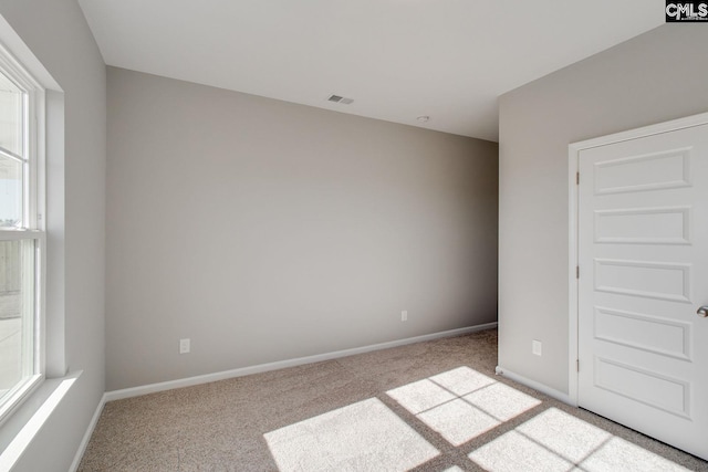 unfurnished bedroom featuring carpet flooring, visible vents, and baseboards