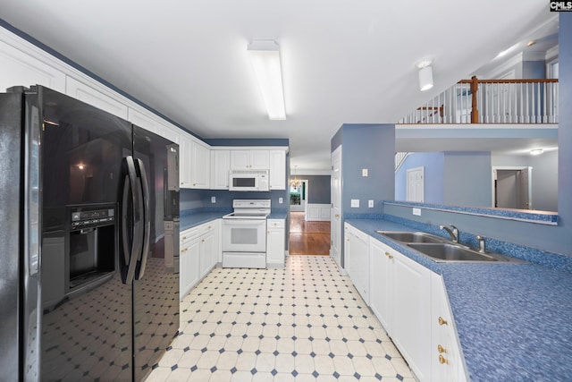 kitchen featuring white cabinetry, white appliances, and sink