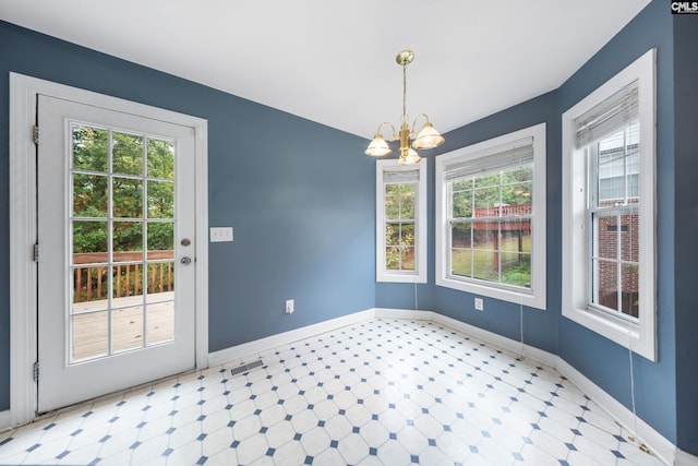 unfurnished dining area with plenty of natural light and an inviting chandelier