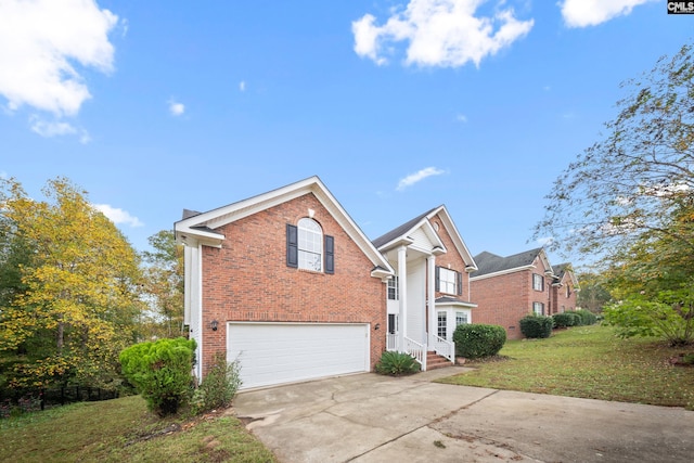 view of property featuring a garage and a front lawn