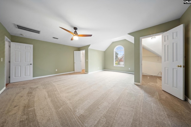 additional living space featuring light colored carpet, lofted ceiling, and ceiling fan