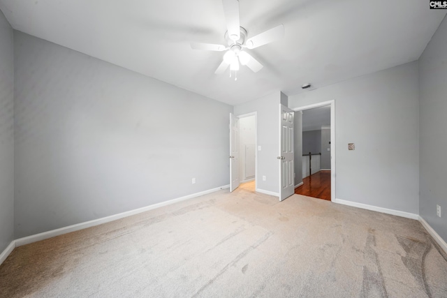 unfurnished bedroom with light colored carpet and ceiling fan