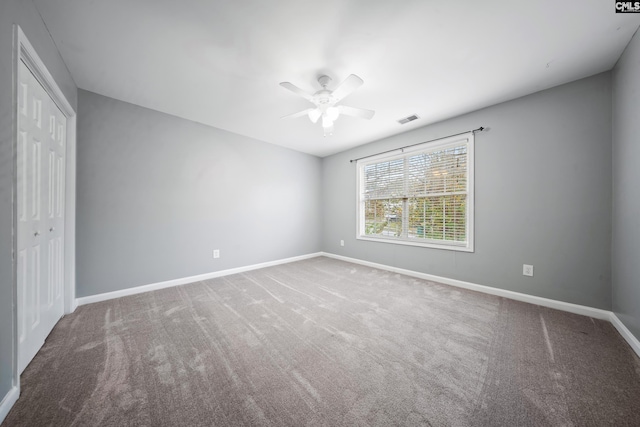 unfurnished bedroom featuring a closet, ceiling fan, and carpet floors