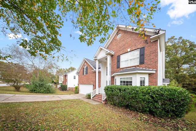 view of front of house featuring a garage and a front lawn