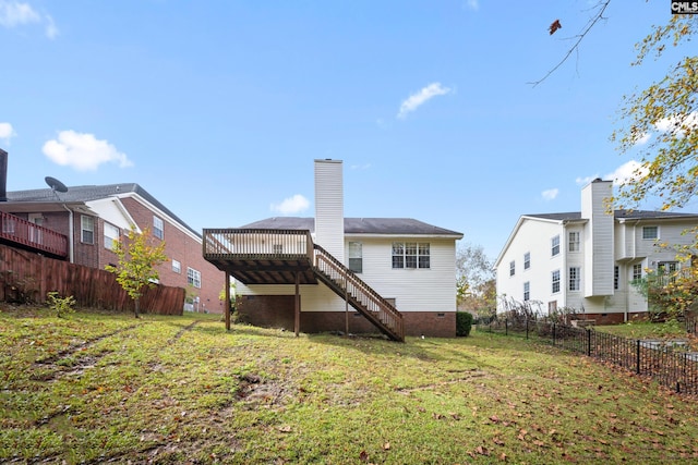 back of property featuring a yard and a deck