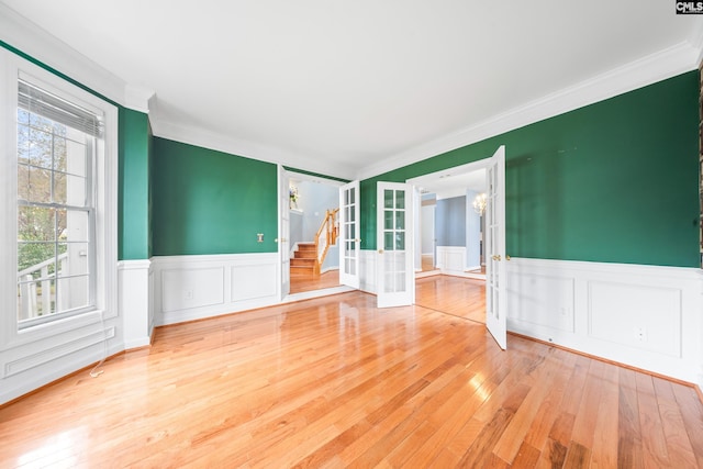 spare room with ornamental molding, hardwood / wood-style floors, and french doors