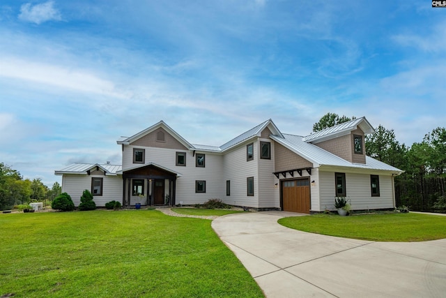 view of front of property with a garage and a front lawn