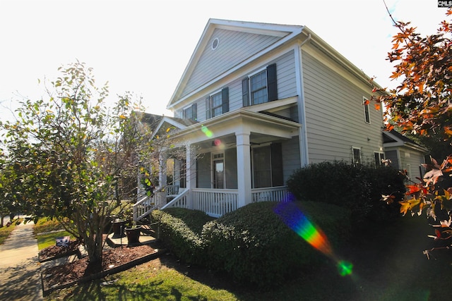 view of property exterior with a porch