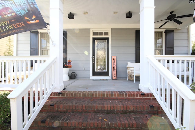 entrance to property featuring a porch and ceiling fan