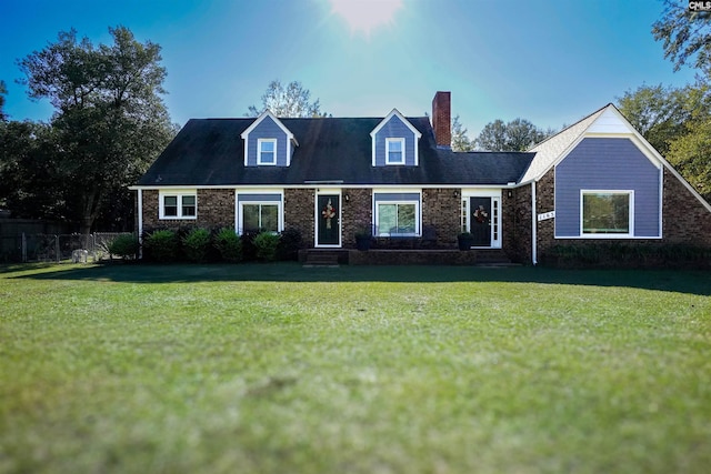 cape cod house featuring a front yard, fence, brick siding, and a chimney