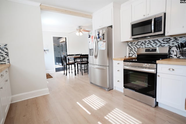 kitchen featuring white cabinets, stainless steel appliances, and tasteful backsplash