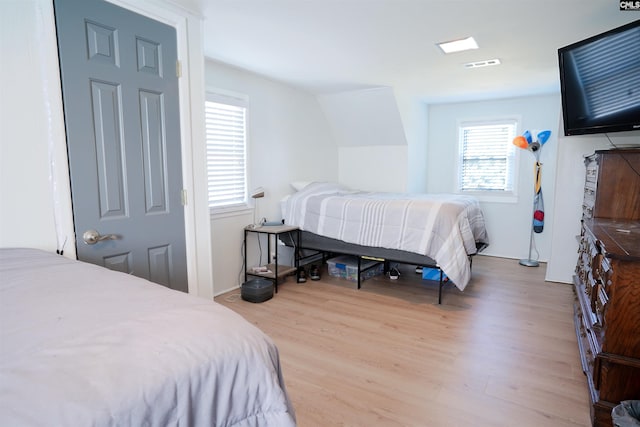 bedroom with wood finished floors and visible vents