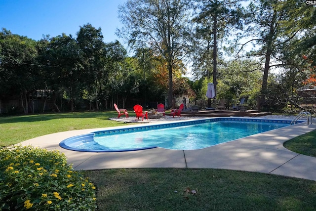 pool featuring a yard, a patio, and a fire pit