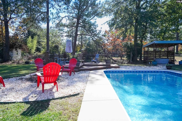 view of pool featuring a patio, a yard, a fire pit, and a gazebo