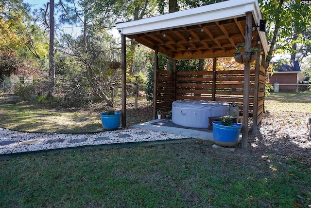 view of yard featuring fence and a hot tub