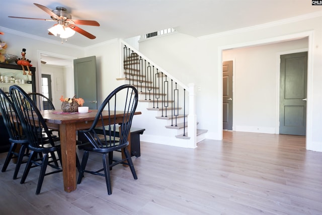 dining area with stairs, baseboards, crown molding, and light wood finished floors