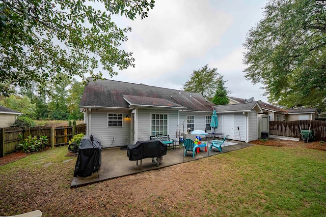 rear view of house featuring a yard and a patio area