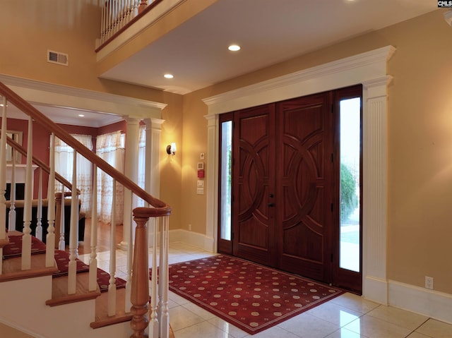 tiled entrance foyer with decorative columns