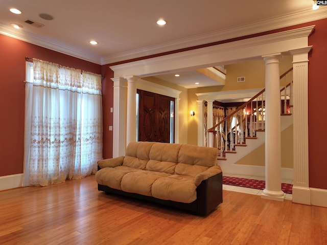 living room featuring wood-type flooring and ornamental molding