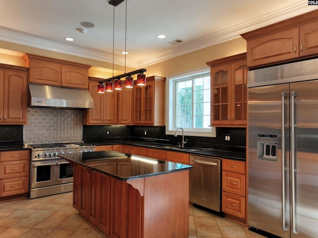 kitchen with a kitchen island, backsplash, hanging light fixtures, and high quality appliances