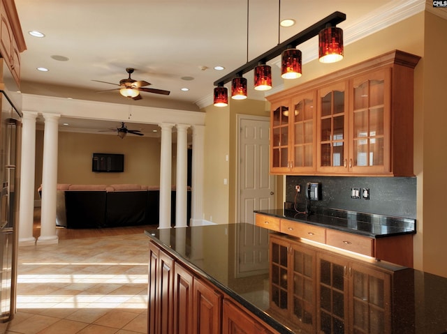 kitchen featuring light tile patterned flooring, decorative columns, tasteful backsplash, and ornamental molding