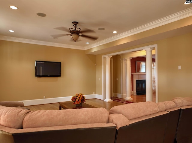 living room featuring ornamental molding, ornate columns, wood-type flooring, and ceiling fan