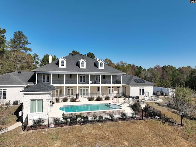 back of house featuring a fenced in pool and a patio area