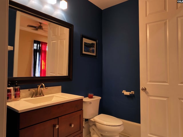 bathroom featuring crown molding, vanity, ceiling fan, and toilet