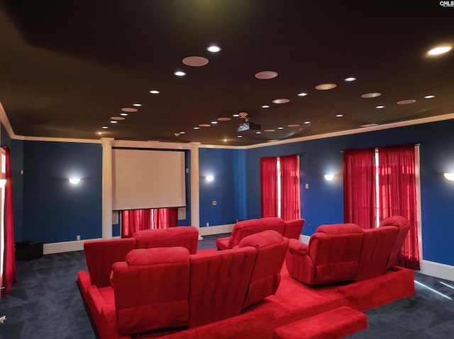 cinema with crown molding and dark carpet