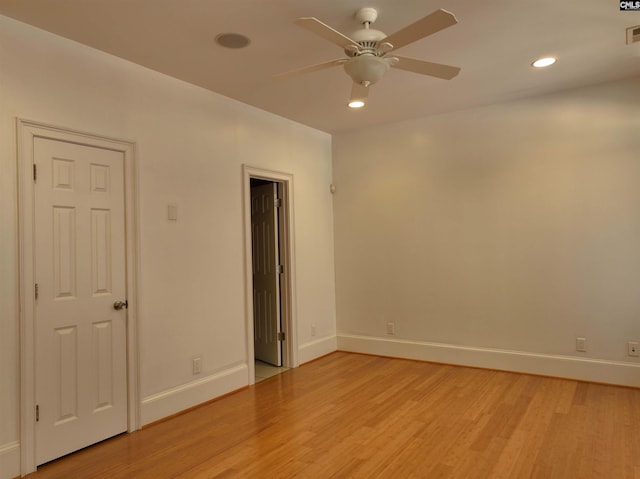 spare room featuring ceiling fan and light hardwood / wood-style flooring