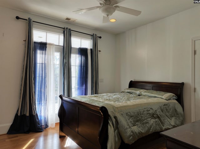 bedroom with light hardwood / wood-style floors and ceiling fan