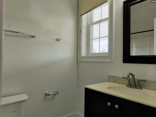 bathroom with toilet and vanity