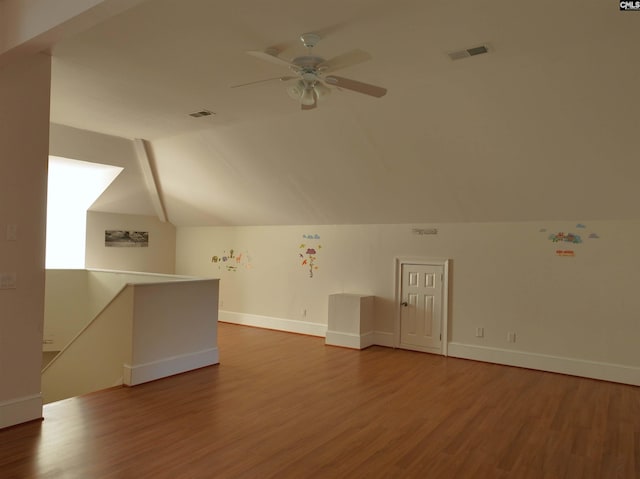 additional living space with lofted ceiling, hardwood / wood-style floors, and ceiling fan