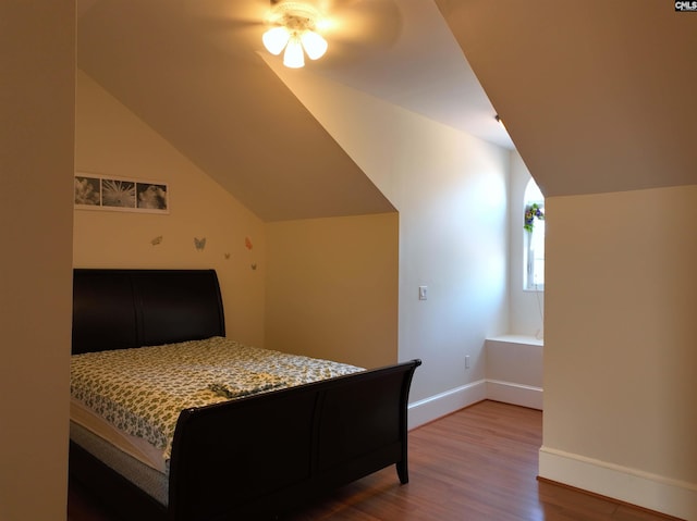 bedroom featuring hardwood / wood-style flooring, ceiling fan, and vaulted ceiling