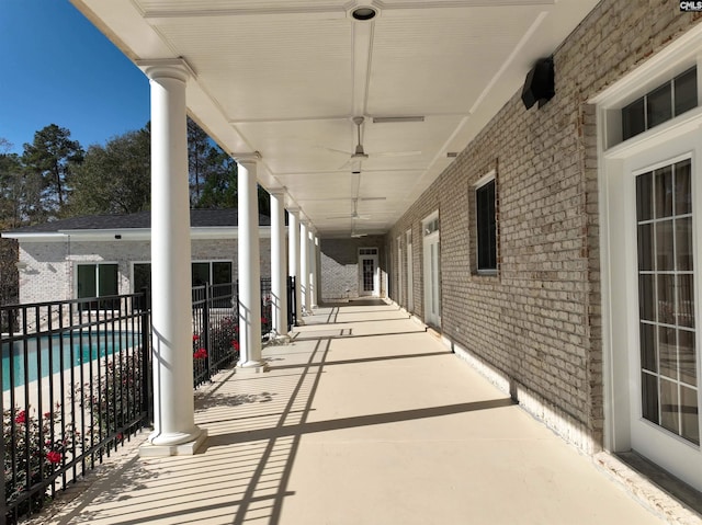 view of patio featuring a fenced in pool and ceiling fan