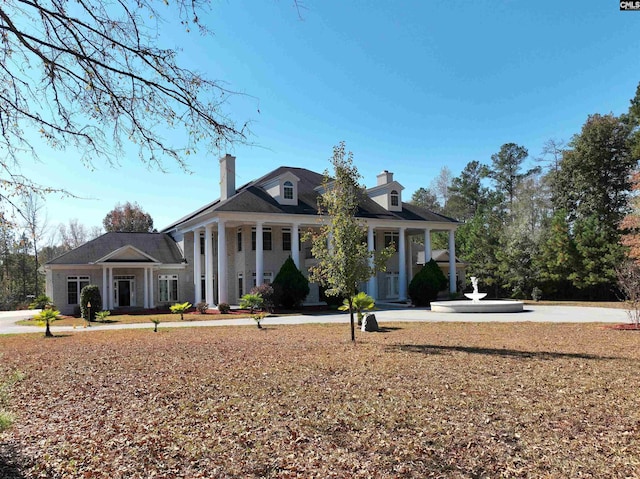 neoclassical home featuring a porch