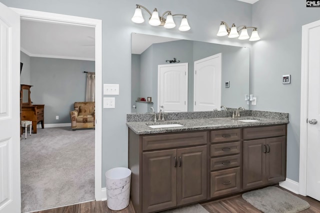 bathroom with wood-type flooring, vanity, and ornamental molding