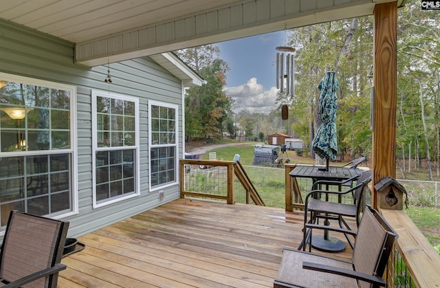 wooden deck featuring a yard