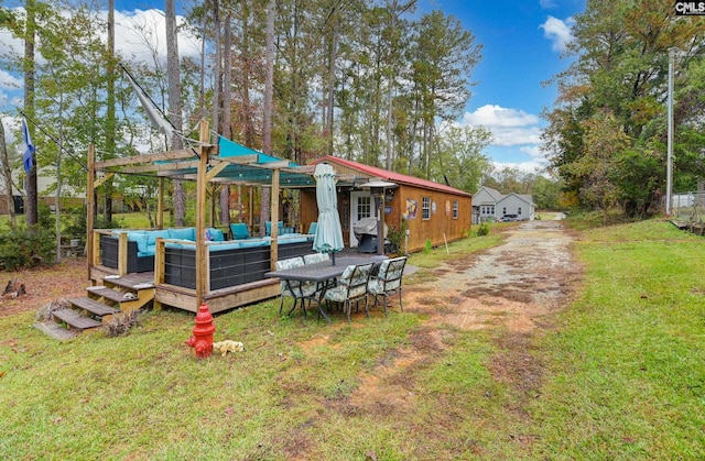 back of property featuring outdoor lounge area and a lawn